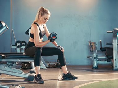 Fitness-asian-woman-doing-exercise-and-lifting-dumbbells-weights-at-sport-gym