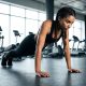 Sporty-woman-performing-push-ups-from-the-floor-in-the-gym